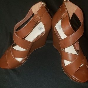 Brown wedge sandal w/ zipper in back.